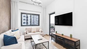 Deluxe Apartment | Living area | 55-inch Smart TV with cable channels, TV
