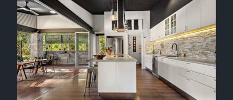 Enjoy meals in the kitchen with a central island, dining area, and large window.