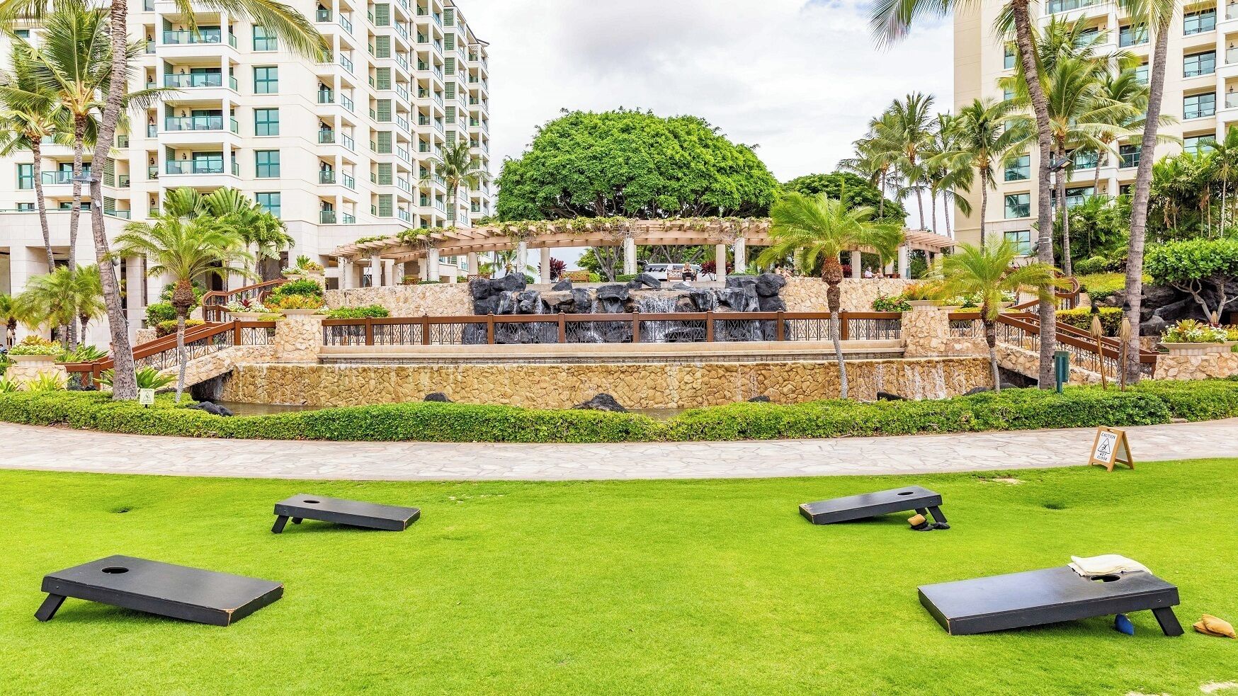 A resort with a pool area, outdoor seating, and a waterfall feature.