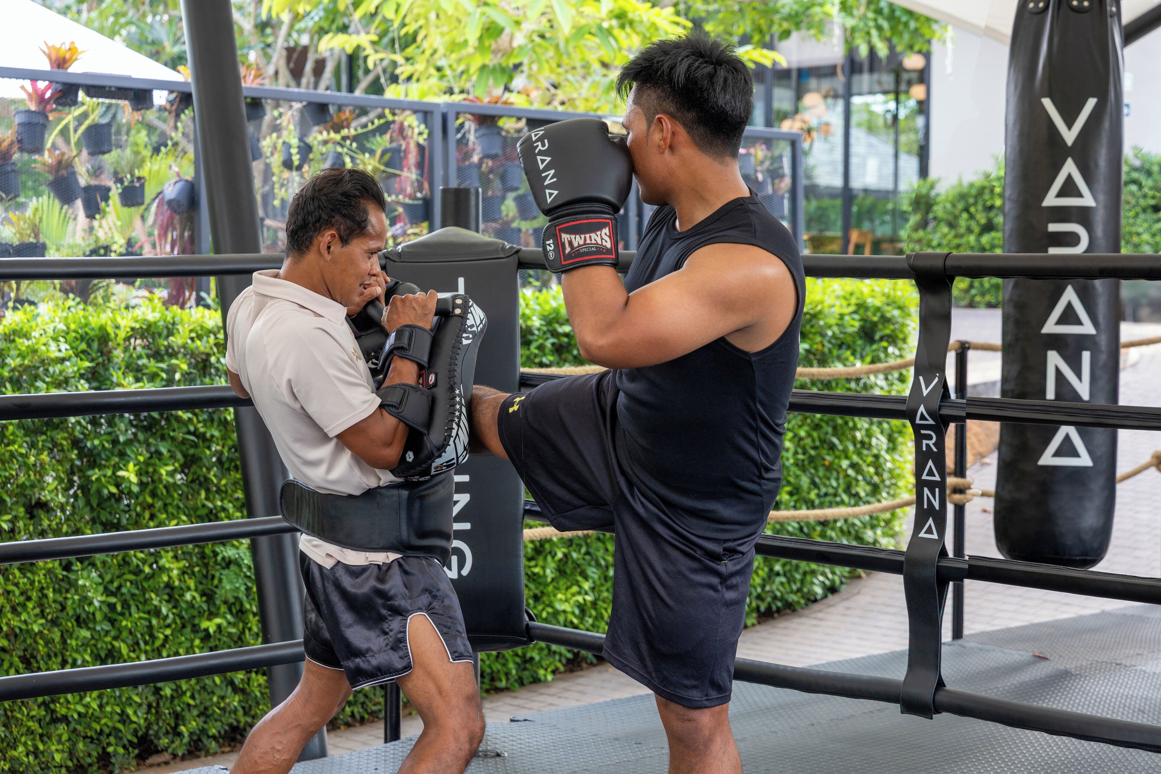 A boxing ring with a person practicing punches.