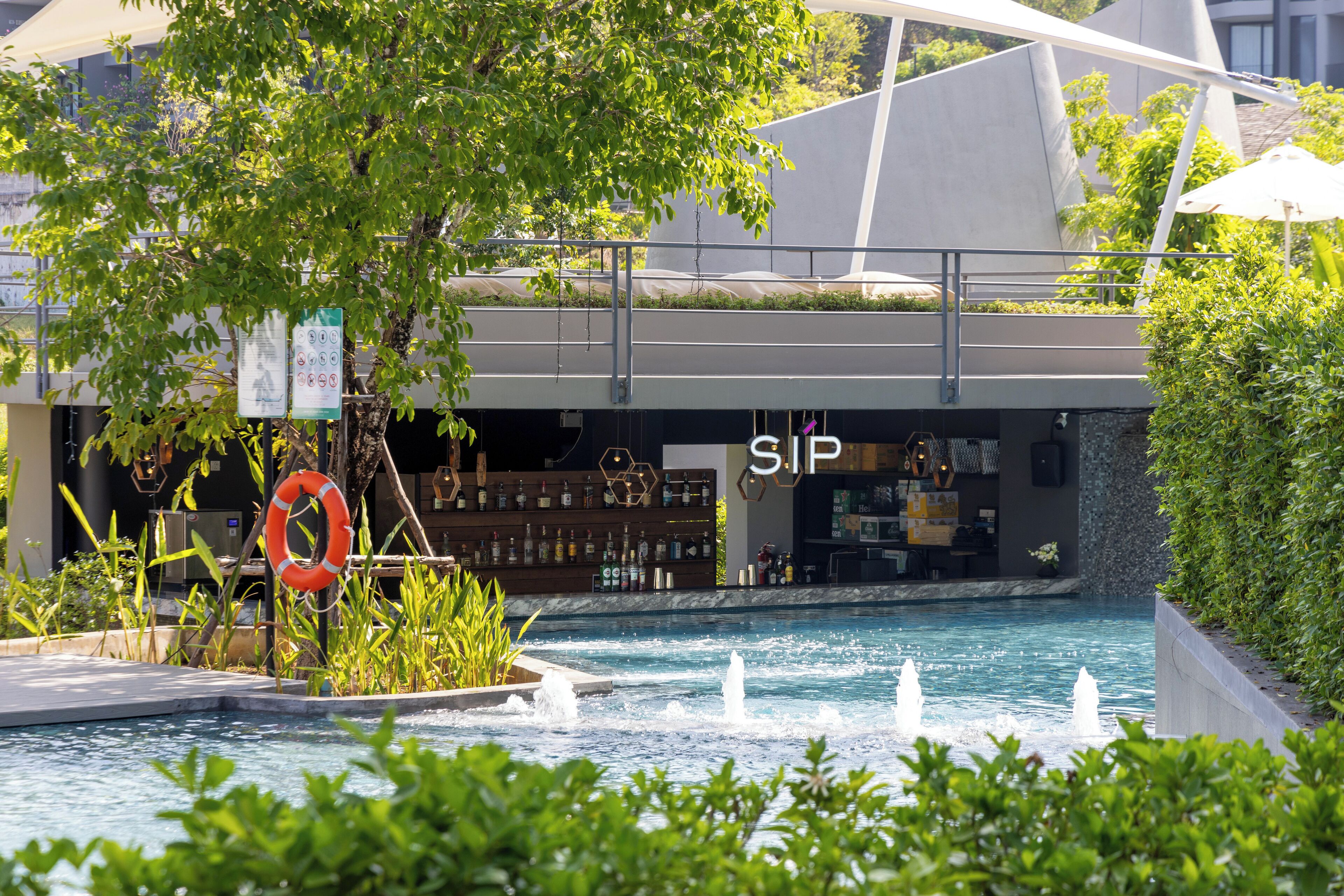 A pool area with a bar and a sign that reads "SIP".