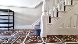 A staircase with white balusters and a patterned floor. - Moorland House by Switchback Stays (Cardiff)
