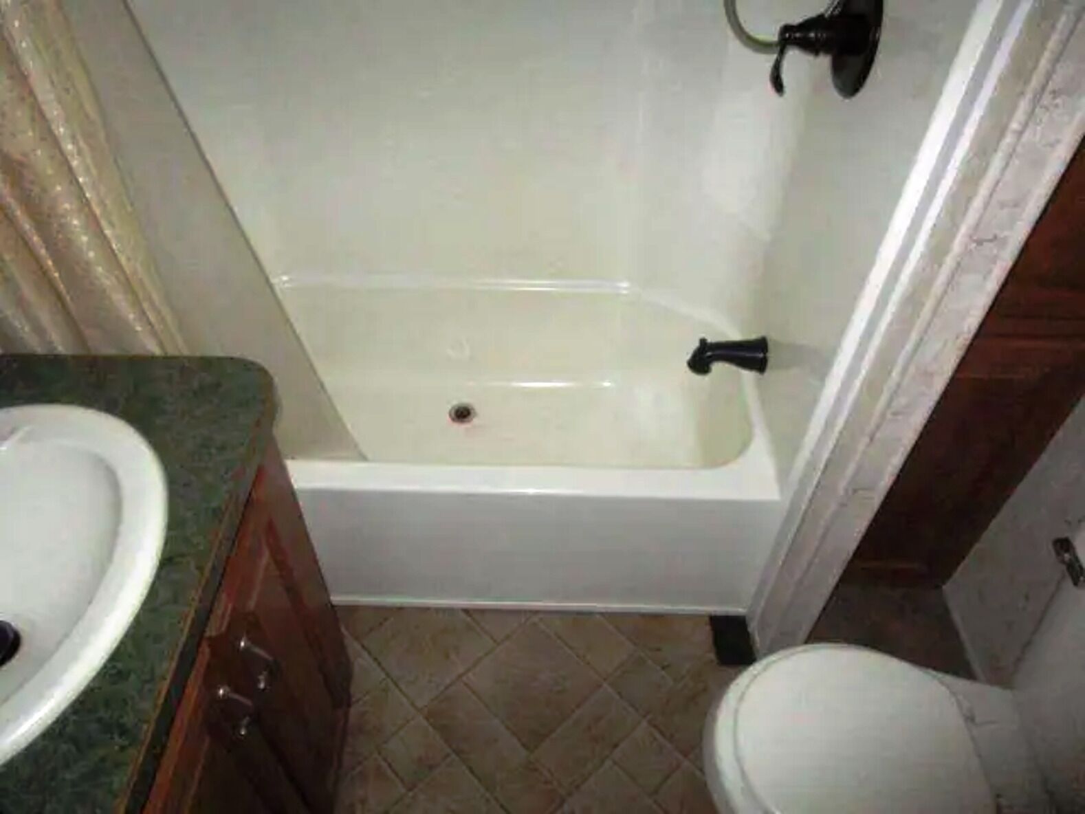 A bathroom with a white bathtub, a sink, and a toilet.