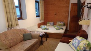 Une pièce confortable avec un lit en bois, un canapé et une petite table.
