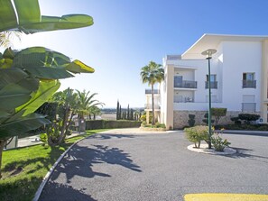 A modern building with a white facade, a central courtyard, and a view of the sea. - Vista Mar by Interhome (Albufeira)