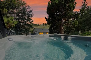 A hot tub area with a house in the background.