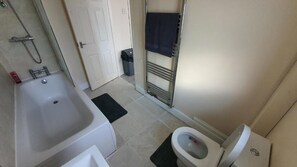 Combined shower/bathtub, towels, soap, toilet paper