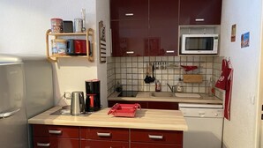 A compact kitchen with a refrigerator, microwave, coffee maker, and a sink. - Superb 32 m2 apartment with GARAGE and slope view (VARS)
