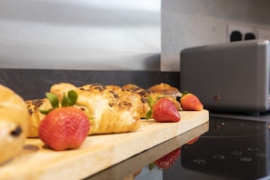 Una tabla de madera con pasteles y fresas.