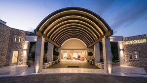 A hotel entrance with a stone facade, a covered walkway, and a sign reading "ANNABELLE". - Annabelle Beach Resort (Hersonnisos, Crete)