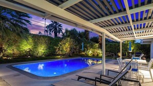 A swimming pool with lounge chairs and a covered patio area. - Alexander in the Sun - Mid‑Century Pet‑Friendly Oasis: Pool, Spa & Mountains (Palm Springs)
