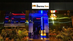 A hotel entrance with a sign for 'The Dorms Inn' and a restaurant sign. - The Dorm Inn (Nashik)