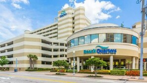 A multi-story hotel with a curved facade and a sign reading "Beach Quarters." - Bch Q 1BR 1BA w Ocean Front Balcony - sleeps 6 (Virginia Beach)