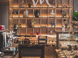 A well-lit room with a wooden bookshelf filled with various decorative items and books. - Mercure Miri City Centre (Miri)