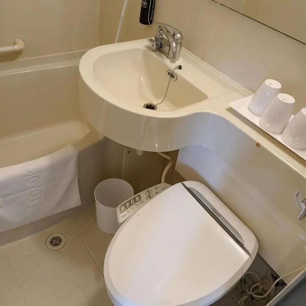 A bathroom with a white sink, toilet, and a towel rack. - Ibis Budget Phnom Penh Riverside (Phnom Penh)