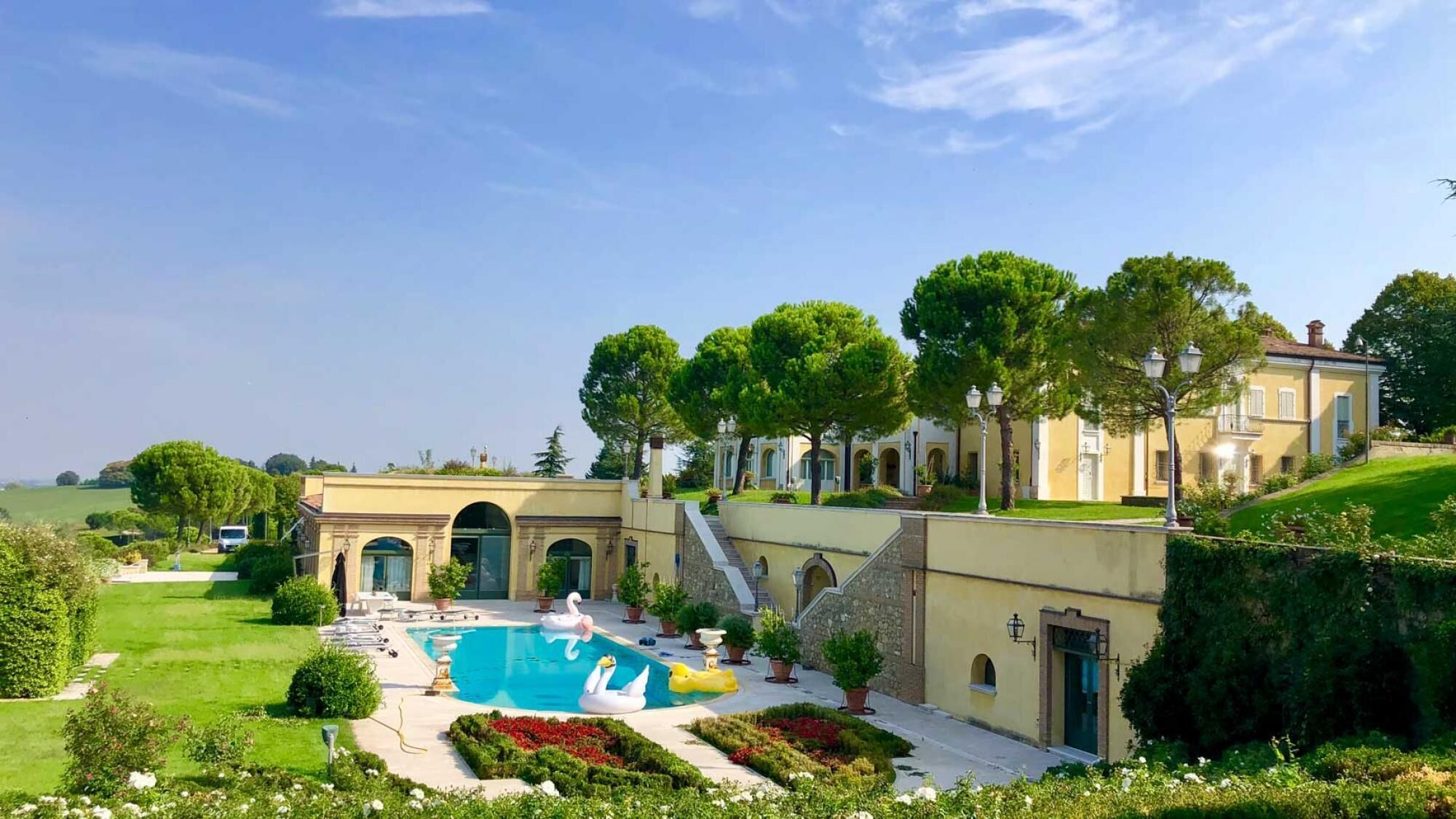 A luxurious villa with a swimming pool, outdoor seating, and a well-maintained garden.