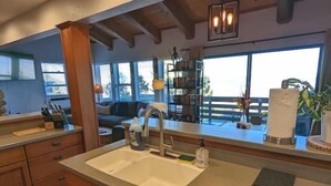 A kitchen with a large island, wooden cabinets, a built-in oven, and a window overlooking a deck. - Mountain Top View, 3 BDRs & 2 Baths, NEW HOTTUB (Stateline)