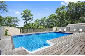 Relax by the pool surrounded by a serene natural setting.