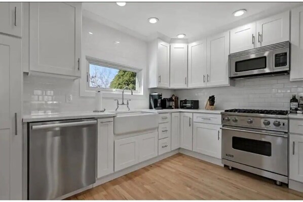 Enjoy cooking in this well-equipped kitchen with a dishwasher, sink, microwave, and oven.