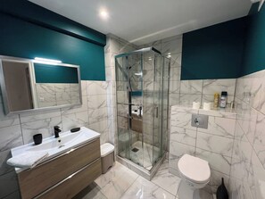 Regadera, toallas, papel de baño