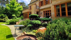 A two-story building with a garden patio, a barbecue area, and a well-maintained lawn. - Stately Home 25 mins to central Warsaw (Magdalenka)