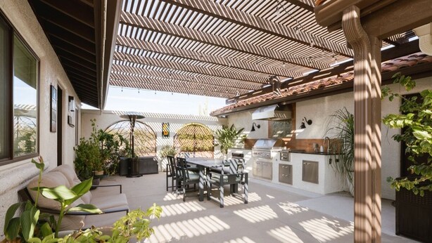 An outdoor patio with a pergola, a dining table, chairs, a grill, and potted plants. - Oasis Casita by Vacay in Tucson - Guesthouse on 4 peaceful desert acres (Tucson)