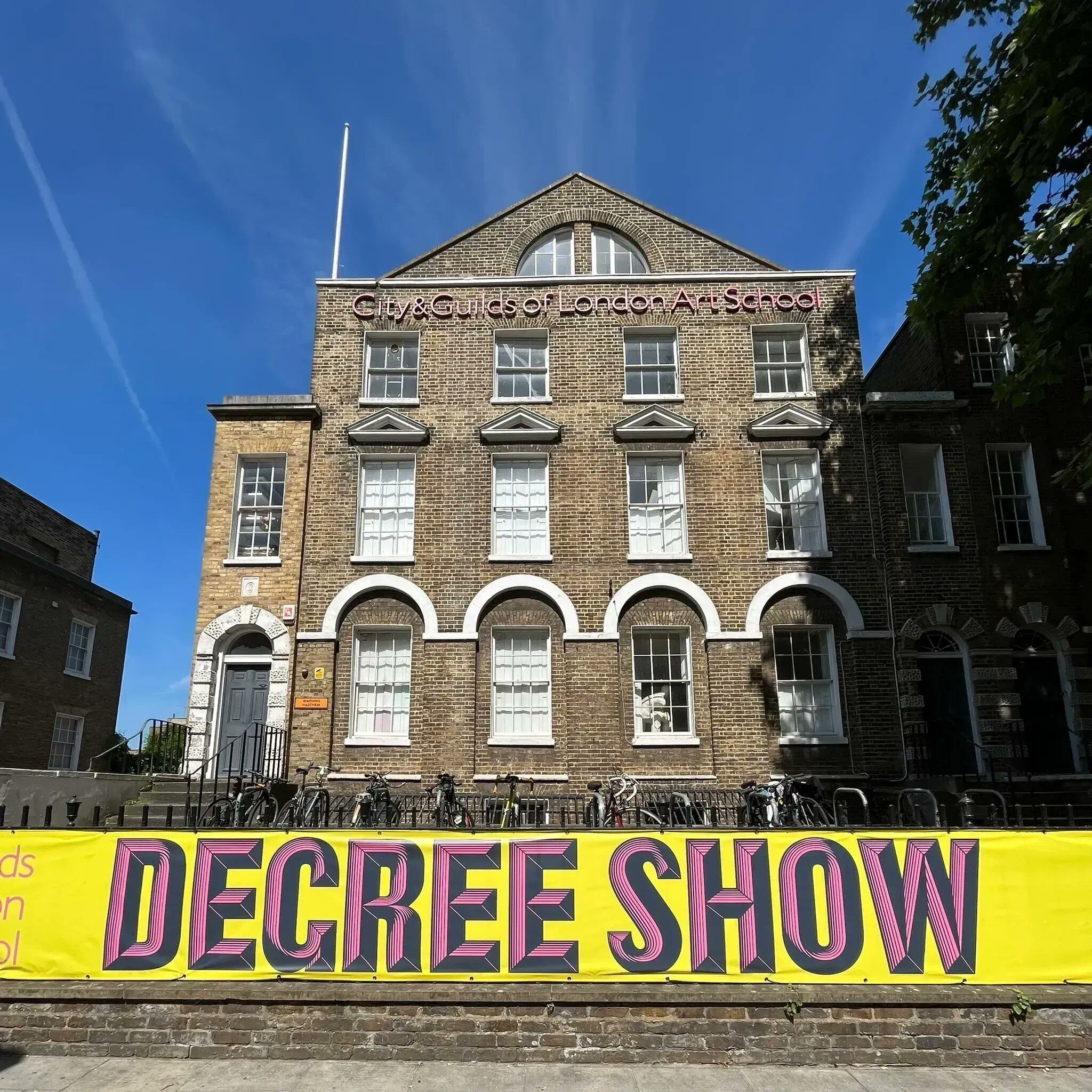Edifici històric amb una finestra apuntada destacada i un banner que diu "DEGREES SHOW".
