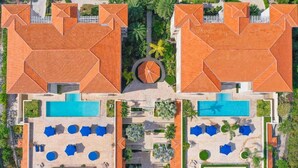 A symmetrical resort layout with two pools, lounge areas, and a central circular feature. - Oasis -1 Studio Condo -Tropical Views -Wifi hot tub & Pool. 10min walk to beach. (TURTLE COVE)