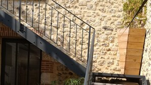 A staircase with metal railings leading to a stone wall. - Escape with Rooftops" with PAID OPTION "JACCUZZI - SAUNA (Fécamp)