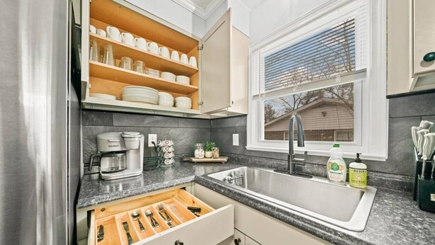 A kitchen with a built-in coffee maker, a sink, and a window with blinds. - Casa Azul: Tranquility + Fire Pit + Gameroom + Peace (Fayetteville)