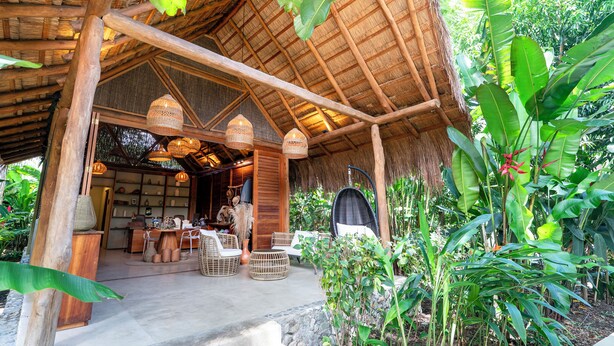 A rustic wooden structure with a thatched roof, wicker furniture, and hanging wicker lamps. - Nativa Refugio Escondido (Sopetrán)