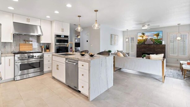 A modern kitchen with white cabinetry, stainless steel appliances, and pendant lighting. - ❤ BRAND NEW POOL, Clean 4BR/3BA Modern Chic Home ❤ (Henderson)