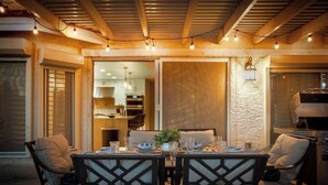 An outdoor dining area with a table set for two, surrounded by cushioned chairs. - ❤ BRAND NEW POOL, Clean 4BR/3BA Modern Chic Home ❤ (Henderson)