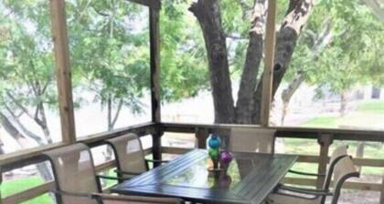 Little cabin sits on river w/ lighted fishing pier