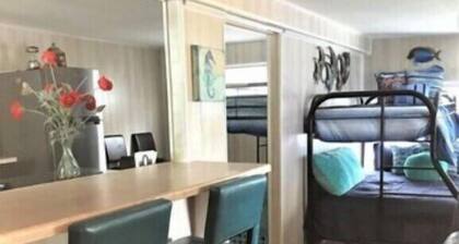 Little cabin sits on river w/ lighted fishing pier