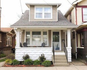 Stunning single-story home with a gabled roof and inviting front porch.