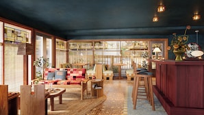 A cozy interior with a wooden bench, a sofa, and a bar area. - Oyster Estate (Greenport)