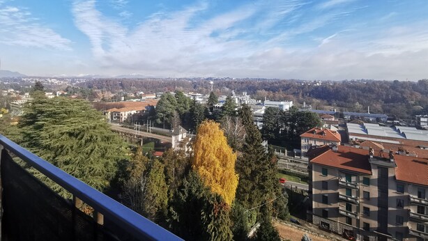 A cityscape with buildings, trees, and a clear sky. - Lovely view - apartment (Albizzate)