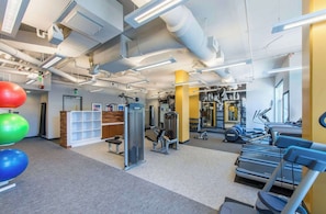A modern gym with exercise equipment, treadmills, and weight machines. - Stylish Comfort Meets Spacious Design (Arlington)