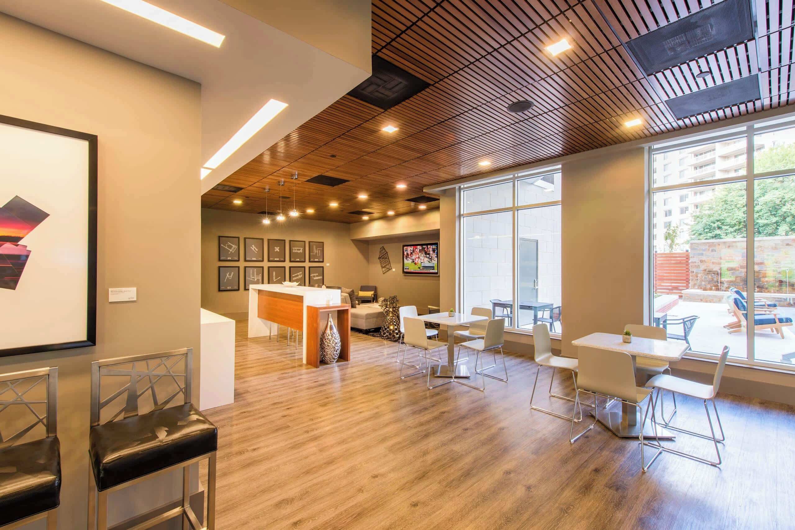 A modern interior with a reception desk, seating area, and large windows.