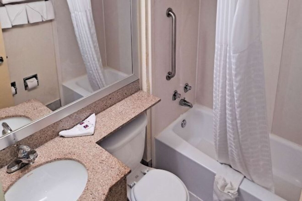 A bathroom with a sink, toilet, and bathtub.