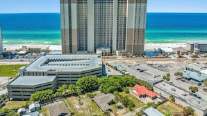 A high-rise hotel with multiple floors, a parking garage, and a beach view. - Tidewater Beach Luxury Penthouse With Resort Amenities and a View! (Panama City Beach)