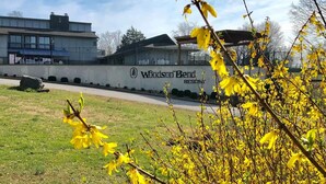 A building with a sign reading "Woodsong Bend Resort."