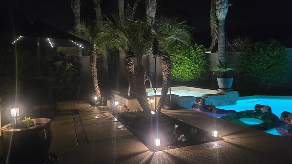 An outdoor pool area with a hot tub, palm trees, and ambient lighting. - "Cactus Cooler Casita" Private Pool and Heated Spa Included Large walk-in Shower (Queen Creek)