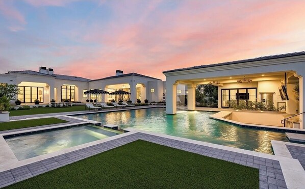 Relax and socialize by the pool, surrounded by lush greenery and comfortable lounge areas.