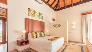 A bedroom with a large bed, wooden headboard, and a nightstand with a lamp. - Bungallow 2 People Private Pool and Garden (Punta Cana)