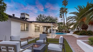 A modern outdoor patio with a fire pit, seating, and a pool. - Minutes from Shopping, Dining & Golf (Scottsdale)