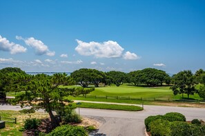 A golf course with a clear sky, well-maintained grass, and trees. - Shelly Shores - Hot tub, community pool & tennis courts, great views (Nags Head)