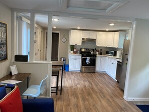 Enjoy cooking in this well-equipped kitchen with a refrigerator, microwave, and oven, and dine in the adjacent dining area.
