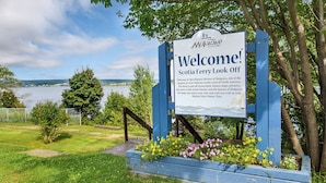 A welcome sign at the entrance of the Scotia Ferry Look Off, featuring a scenic view of a lake and surrounding greenery. - Mulgrave Vila (Mulgrave)